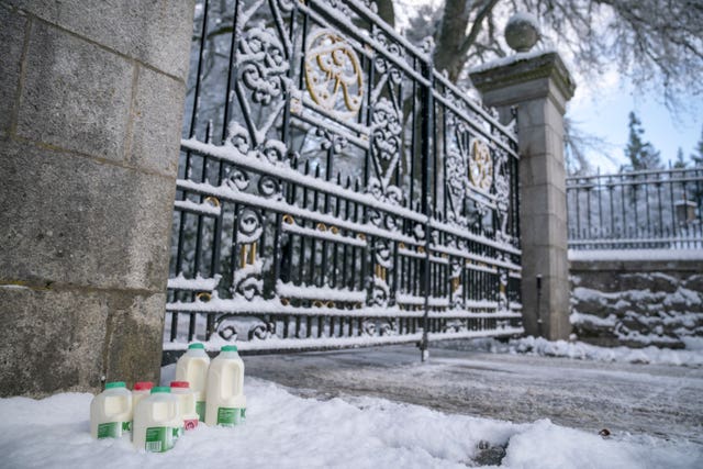 Milk is left in the snow by the gate at the entrance to Balmoral Castle