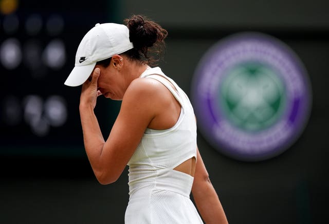 An upset Madison Keys covers her eyes with her hand