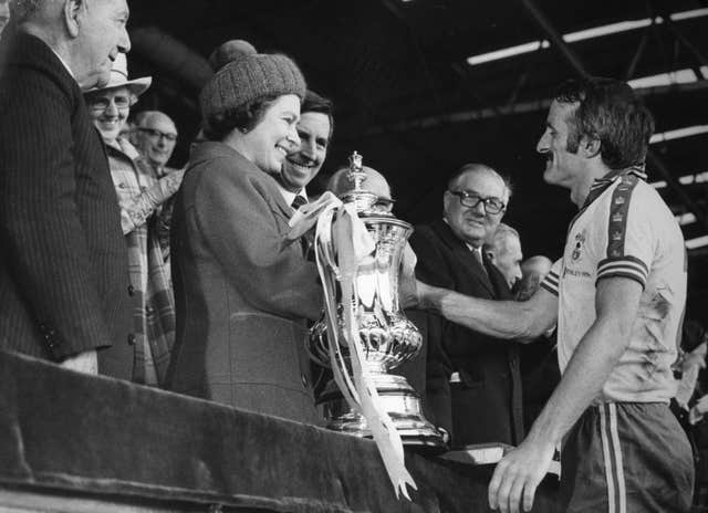 Queen Elizabeth presents Southampton captain Peter Rodrigues with the FA Cup at Wembley