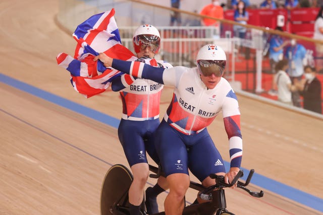 Neil Fachie and pilot Matt Rotherham celebrate after winning men's B 1000m time trial gold