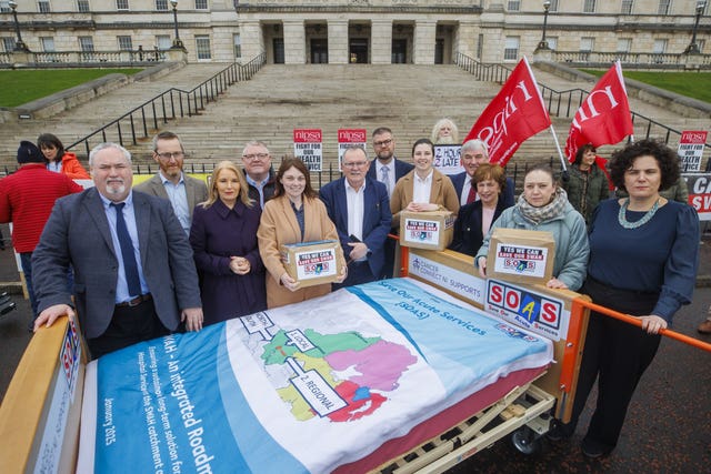 Political representatives from Sinn Fein, the DUP and SDLP holding boxes of letters from SOAS campaigners