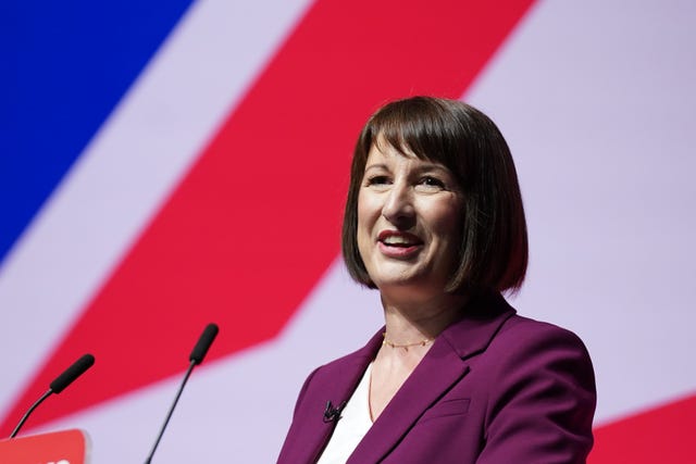 Rachel Reeves speaking on a lectern with a British flag background