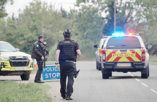 Police officers and police cars on a road