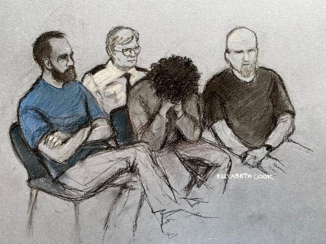 Court artist drawing by Elizabeth Cook of 17-year-old Axel Rudakubana (centre) covering his face as he appeared in the dock at Liverpool Crown Court. 