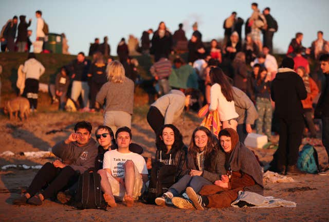 Rather you than me - these students kept watch from the shore (Jane Barlow/PA)