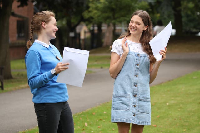 Sophie Lofthouse, left, and Hannah Walton-Hughes react as students at The Mount School, York, receive their A-level results