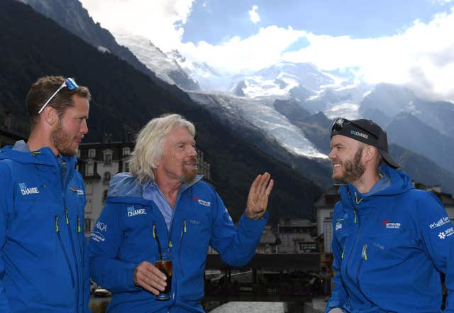 Sir Richard relaxes with his son Sam and nephew Noah Devereux, right, after their climb