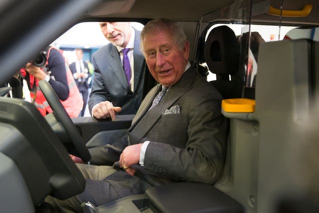 The Prince of Wales is shown a new model taxi at the London EV Company in Coventry