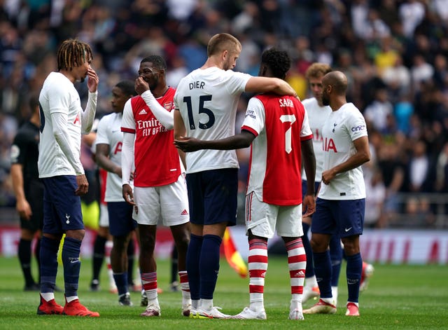 Bukayo Saka embraces Tottenham's Eric Dier after receiving support from Spurs fans