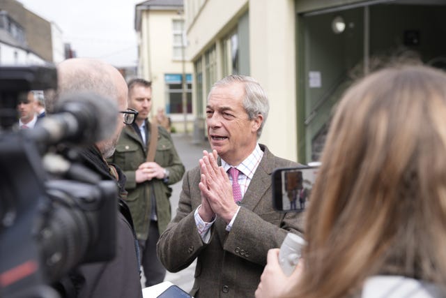 Reform UK leader Nigel Farage speaking to the media during a walkabout in Merthyr Tydfil, South Wales