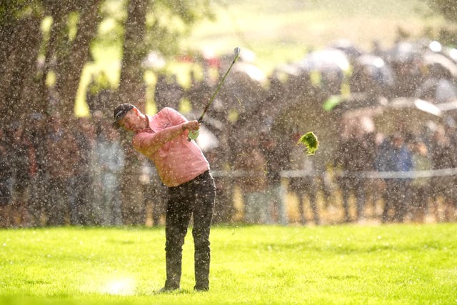 Justin Rose plays from the 17th fairway in heavy rain at the 2025 BMW PGA Champioonship 