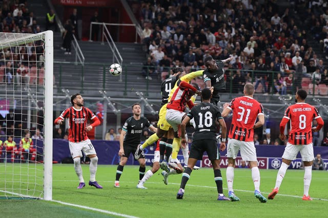 Ibrahima Konate, centre right, rises above a crowd of players and in front of goalkeeper Mike Maignan to head Liverpool''s equaliser against AC Milan