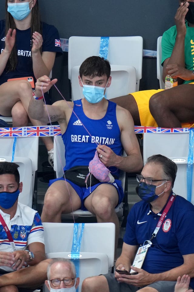 Great Britain’s Tom Daley knits in the stands during the Women’s 3m Springboard Final at the Tokyo Aquatics Centre on the ninth day of the Tokyo 2020 Olympic Games in Japan. Picture date: Sunday August 1, 2021