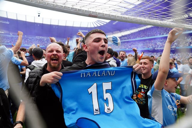 Manchester City fans invade the pitch after full-time