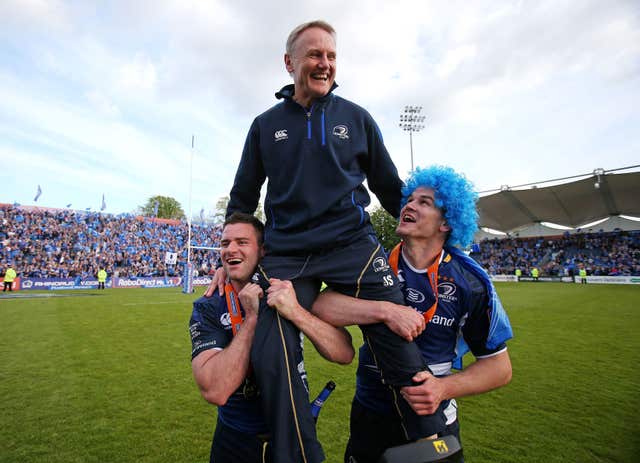 Leinster’s Jonny Sexton and Fergus McFadden carry their coach Joe Schmidt (centre) as they celebrate on the pitch