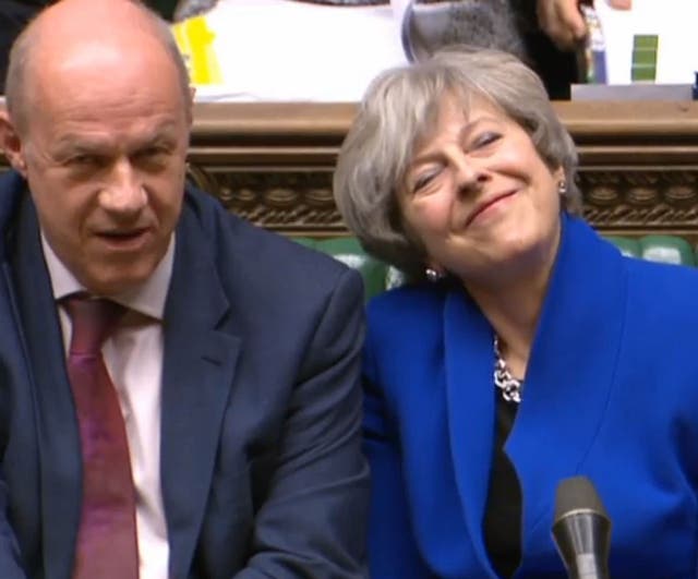 Prime Minister Theresa May smiles as she sits alongside Damian Green at Prime Minister's Questions. (PA)