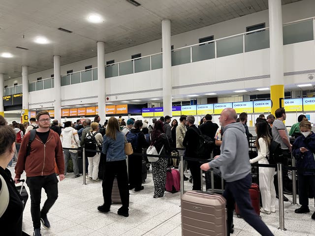 There have been lengthy queues at some of Britain's airports during half-term (Stephen Jones/PA)