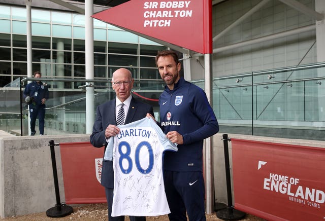 Sir Bobby Charlton, left, is presented by current manager Gareth Southgate with an England shirt to mark his 80th birthday in 2017