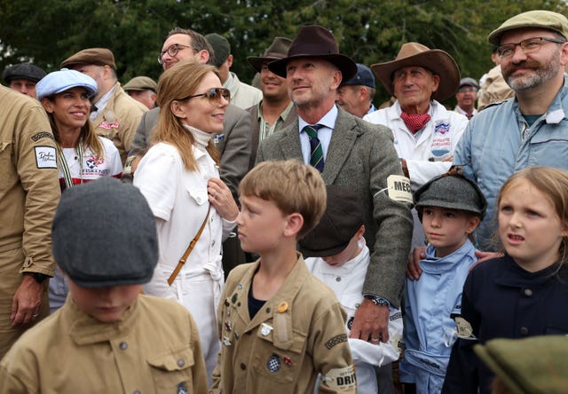 Geri Horner and husband Christian Horner stand with other people at the festival