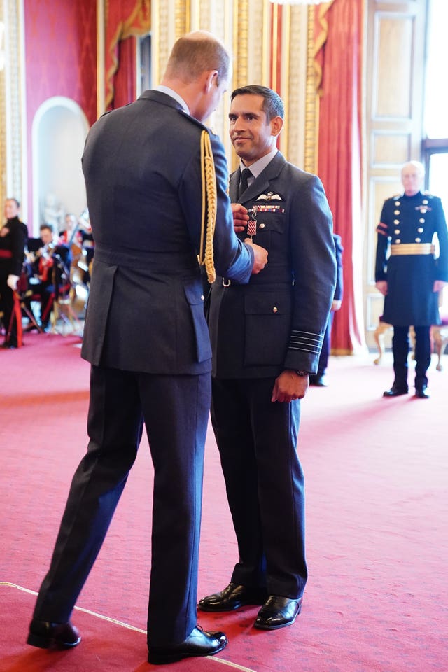 Group Captain Kevin Latchman, Royal Air Force, is decorated with the Air Force Cross by the Prince of Wales at Buckingham Palace