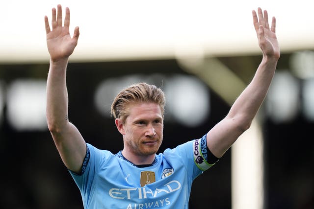 Kevin De Bruyne raises his arms during a game for Manchester City