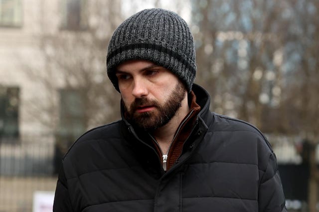 Declan McNally wearing a hat while walking outside court