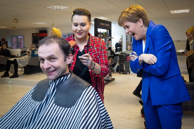 SNP leader Nicola Sturgeon gives her party’s candidate for North East Fife Stephen Gethins a haircut at Craig Boyd Hairdressing in Leven, Fife