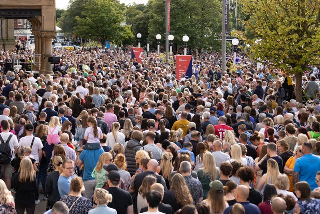 Members of the public taking part in a vigil in Southport