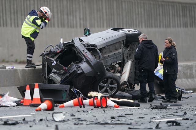 Police examine one of the vehicles after the collision 