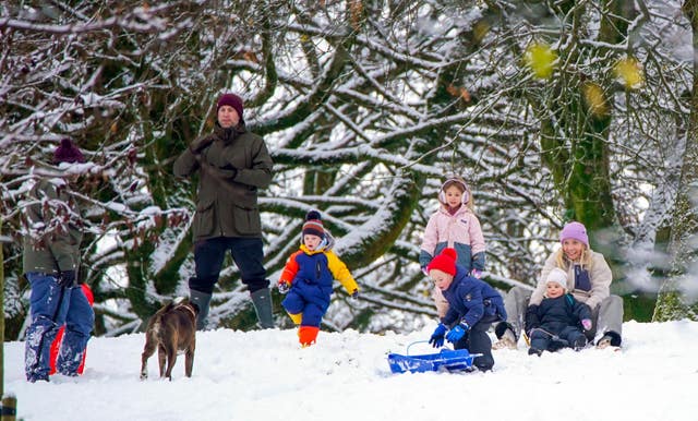 Families sledging in snow