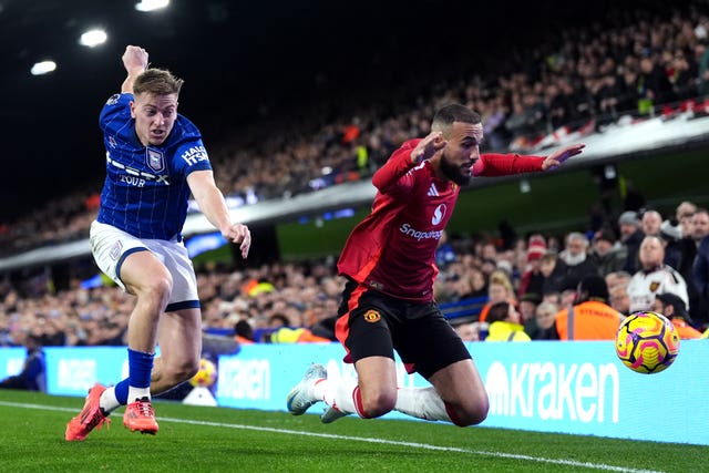 Ipswich’s Liam Delap (left) battles for the ball with Manchester United’s Noussair Mazraoui