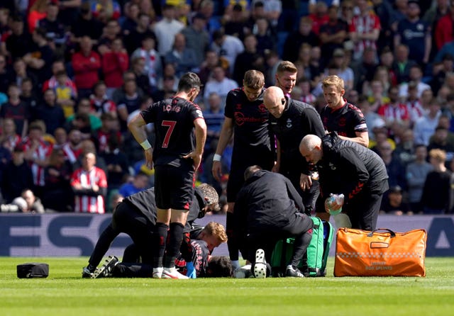 Tino Livramento receives medical attention after sustaining a serious knee injury as Southampton played at Brighton in April 2022