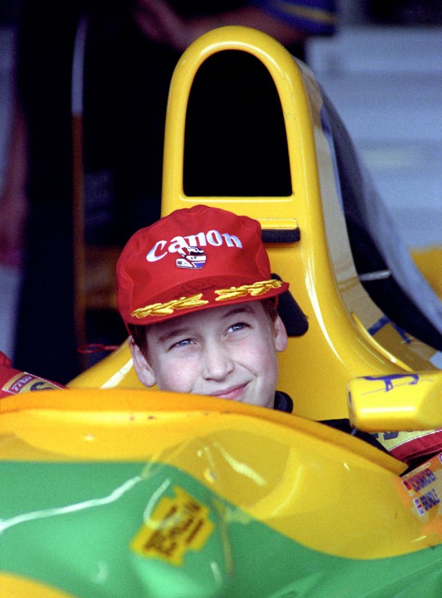 Prince William sits in the driving seat of a Benetton car at Silverstone during a pit visit prior to the 1992 Grand Prix