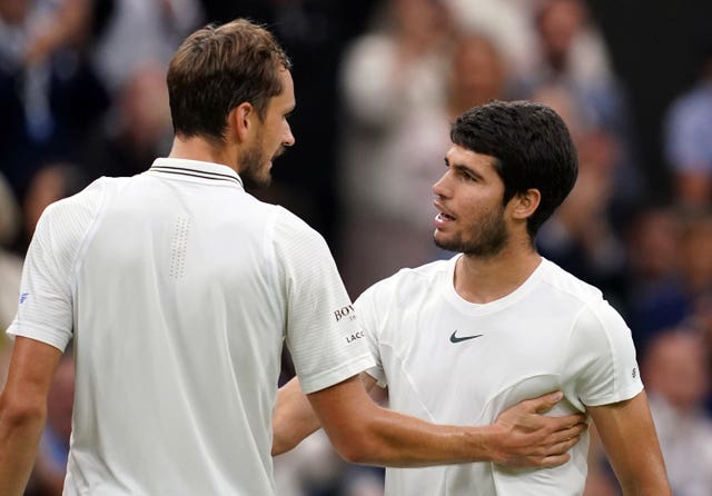 Carlos Alcaraz greets Daniil Medvedev at the net