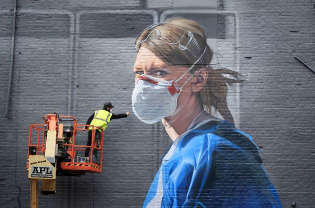 Artist Peter Barber working on a mural in Manchester city centre 