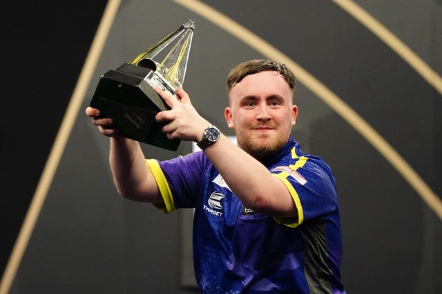 Luke Littler holds the Premier League trophy