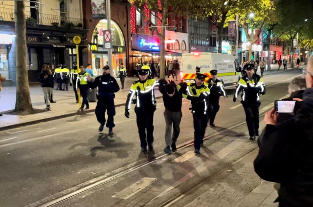 Police detain a man on O’Connell Street in Dublin following violent scenes in the city centre in November 2023