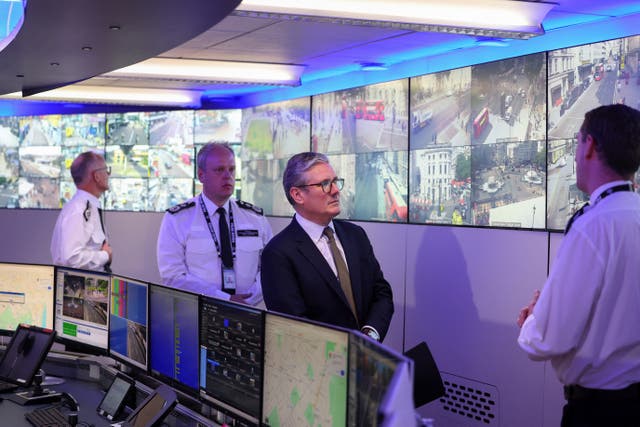 Sir Keir Starmer visits a police operations room covered with screens