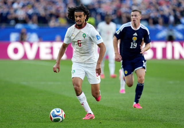 Morocco’s Ayyoub Bouaddi runs with the ball pursued by Scotland's Lewis Ferguson