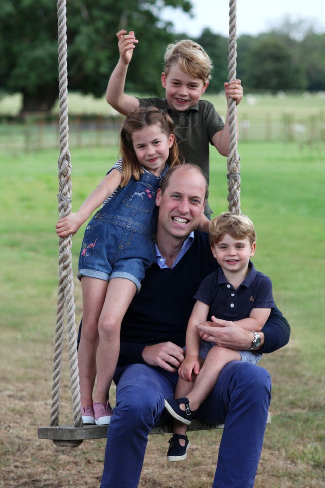 The Cambridges on a swing