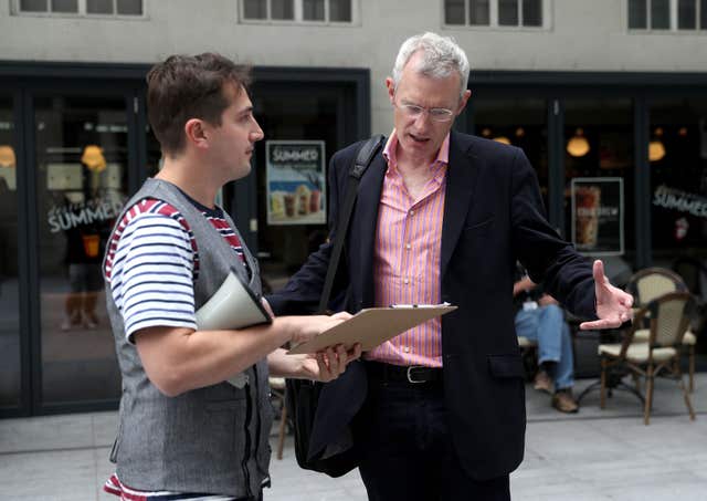 Comedian Luke McQueen asks Jeremy Vine to sign his petition at his mock protest (Andrew Matthews/PA) 