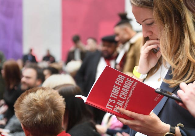 Woman reads Labour manifesto