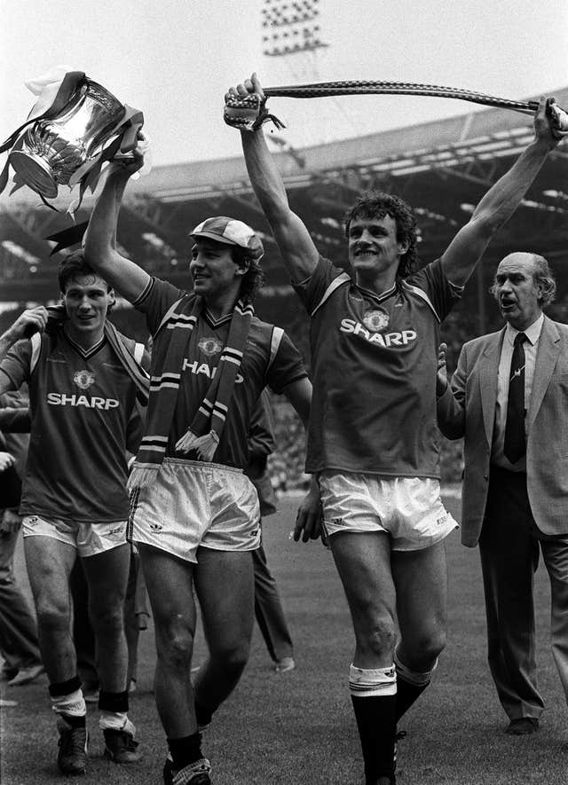 Manchester United captain Bryan Robson shows off the FA Cup after beating Everton in 1985