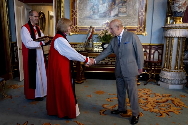 The Bishop of Hereford, the King’s Clerk of the Closet, watches as the King meets the Archbishop of Canterbury Dame Sarah Mullally 