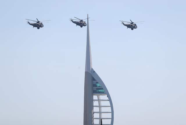Three Royal Navy Sea King helicopters fly past the Spinnaker tower