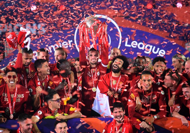 Liverpool captain Jordan Henderson (centre) celebrates with his team as they lift the Premier League trophy