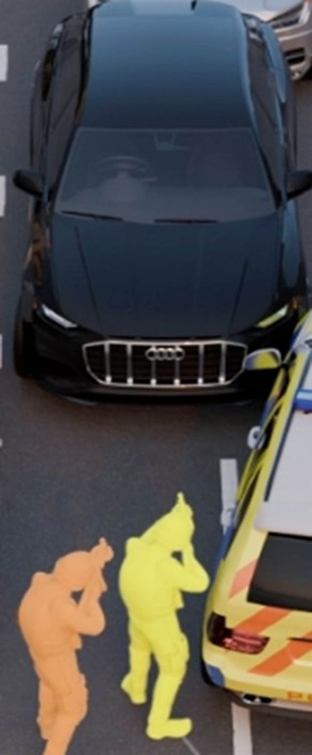 A computer-generated image of the position of Martyn Blake, yellow figure, and another firearms officer, orange, in front of the Audi in which Mr Kaba was fatally shot 