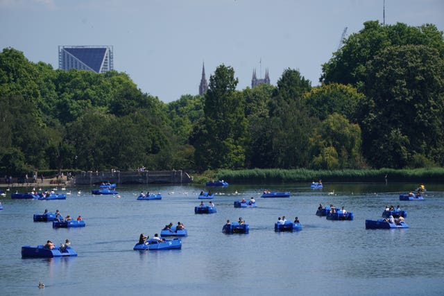 People in pedalos on the Serpentine, Hyde Park, London 