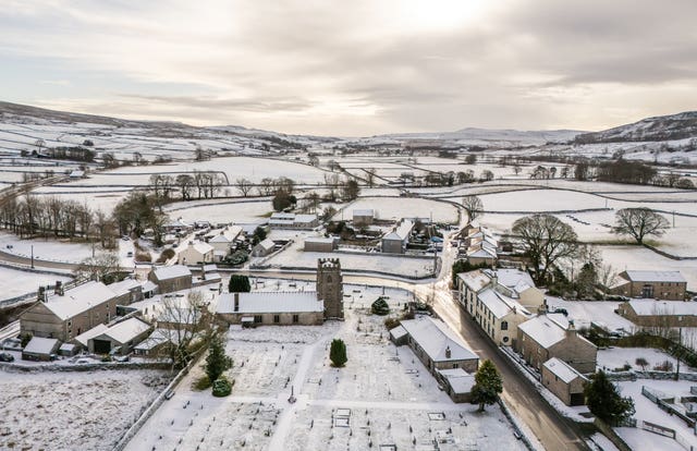 Aerial view of snow-covered fields and buildings