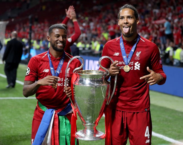 Virgil van Dijk (right) and Georginio Wijnaldum (left) with the Champions League trophy in 2019